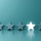 Five stars against a blue background. The fourth star is lit up.