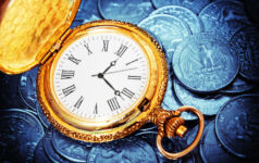gold watch against US currency