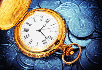 gold watch against US currency