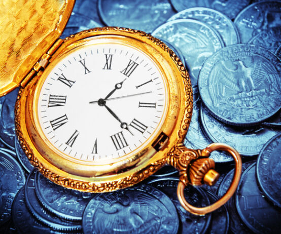 gold watch against US currency