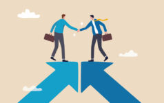 Blackstone Strategic Partners: Looking beyond capital Two people stand on converging arrows and shake hands.