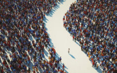A crowd of people parts with one person left in the space between