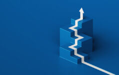 A white arrow painted on the blue floor climbs isometric steps