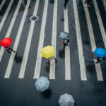 Blackstone, CVC, Oaktree eye Asia in global insurance build-out Group of people with umbrellas on the crosswalk, walking the street of Taipei on a rainy day.