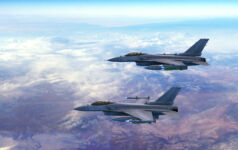 Two fighter jets flying together above clouds over Europe