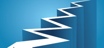 An illustration of a businessperson standing at the beginning of a long, zig-zagging road