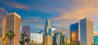 Dusk light with dramatic clouds in downtown Los Angeles and freeway, California.