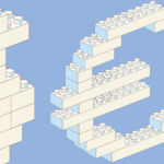 Toy building blocks in the shape of a dollar sign and euro sign