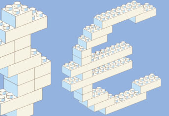 Toy building blocks in the shape of a dollar sign and euro sign
