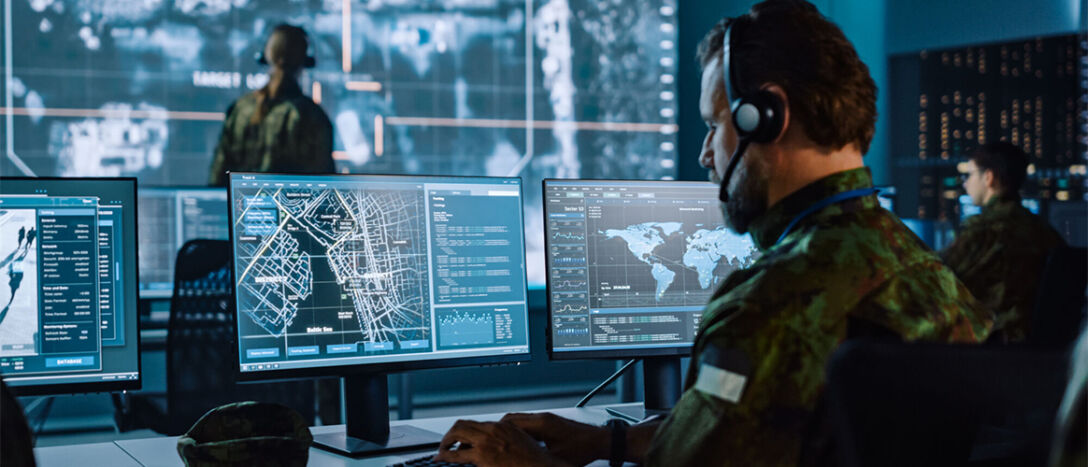 command-centre A military command and communications centre with operatives looking at urban maps on computer screens