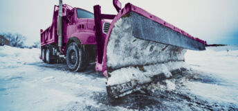 Snow plough clearing snow