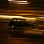 Night shot of a London Black Cab on motion blur background.