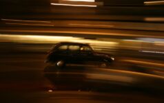 Night shot of a London Black Cab on motion blur background.