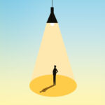 Man stands under light