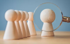 magnifying glass on pawns