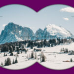 View through binoculars of a snowy mountain