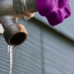 An outdoor tap with an icicle frozen to the nozzle