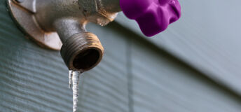 An outdoor tap with an icicle frozen to the nozzle