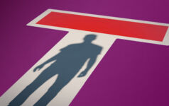 Shadow in a doorway with a no-entry sign on it