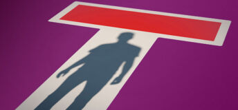 Shadow in a doorway with a no-entry sign on it