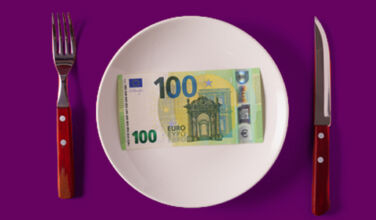 A photo of a knife, fork and plate with cash on the plate