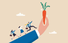 Three people chasing a carrot up someone's arm